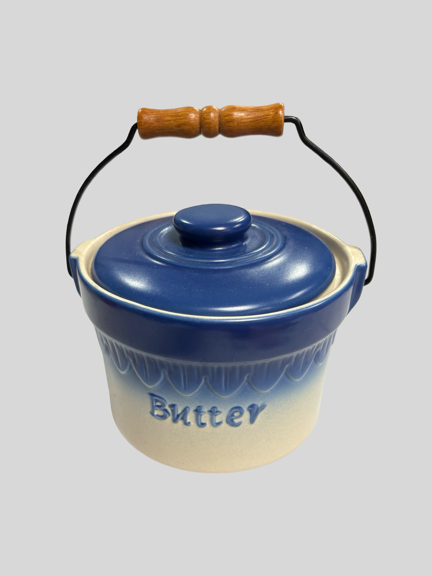 Blue vintage pottery with wood handle